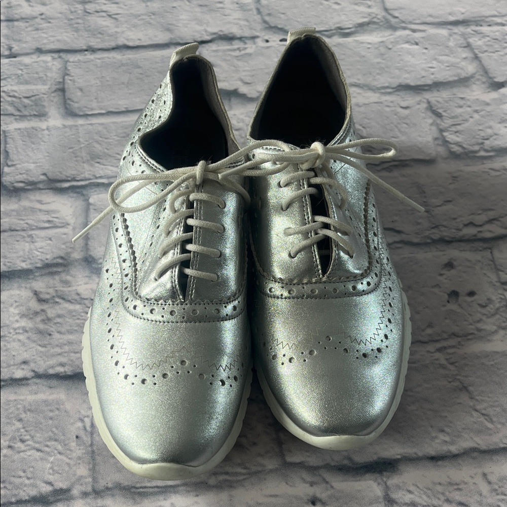 Cole Haan ZERØGRAND Wingtip Oxfords in a silver metallic leather finish.
